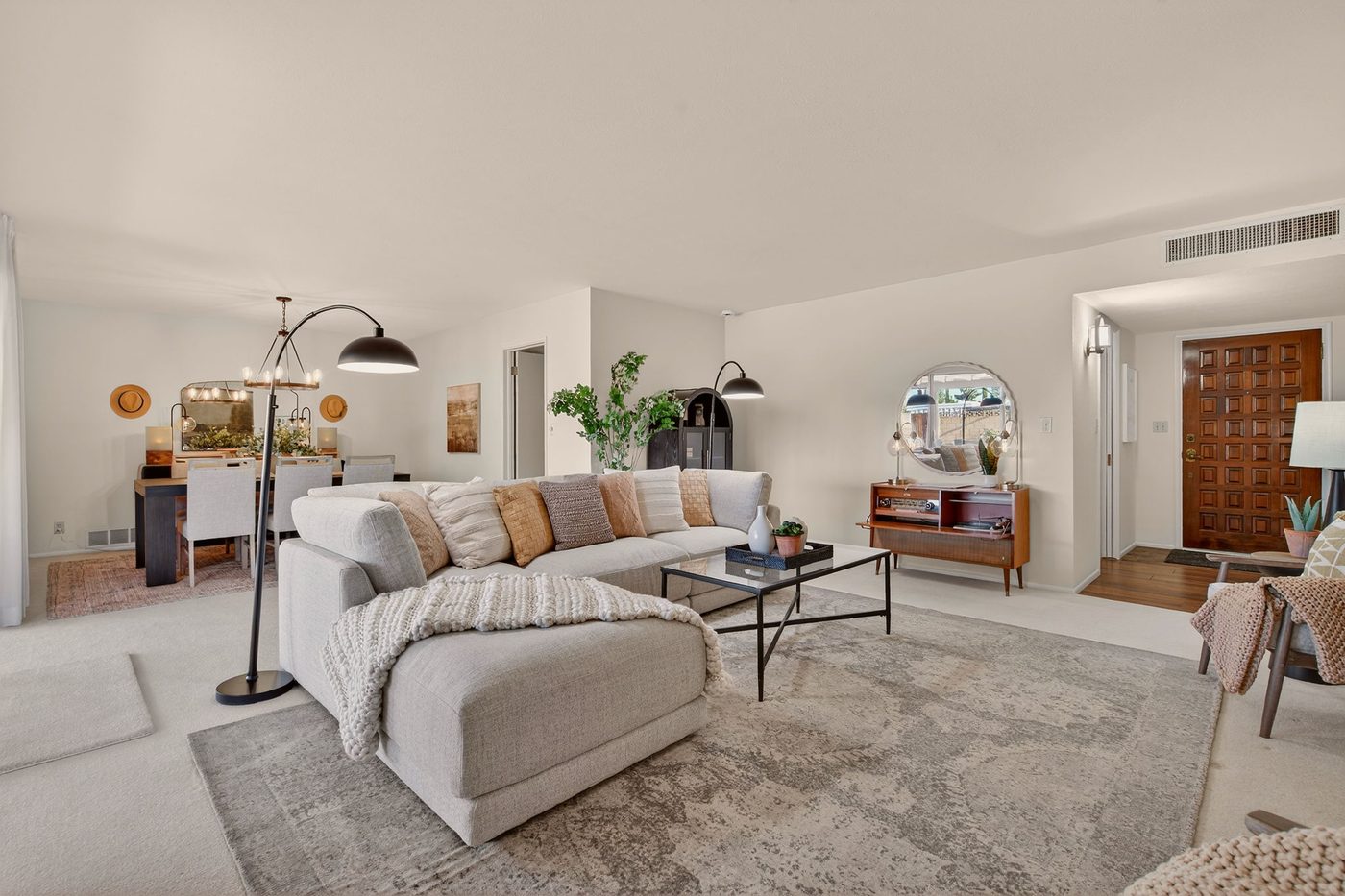 The mid-century living and dining rooms at 5910 E Edgemont Ave in Scottsdale, staged by Lynda Redding