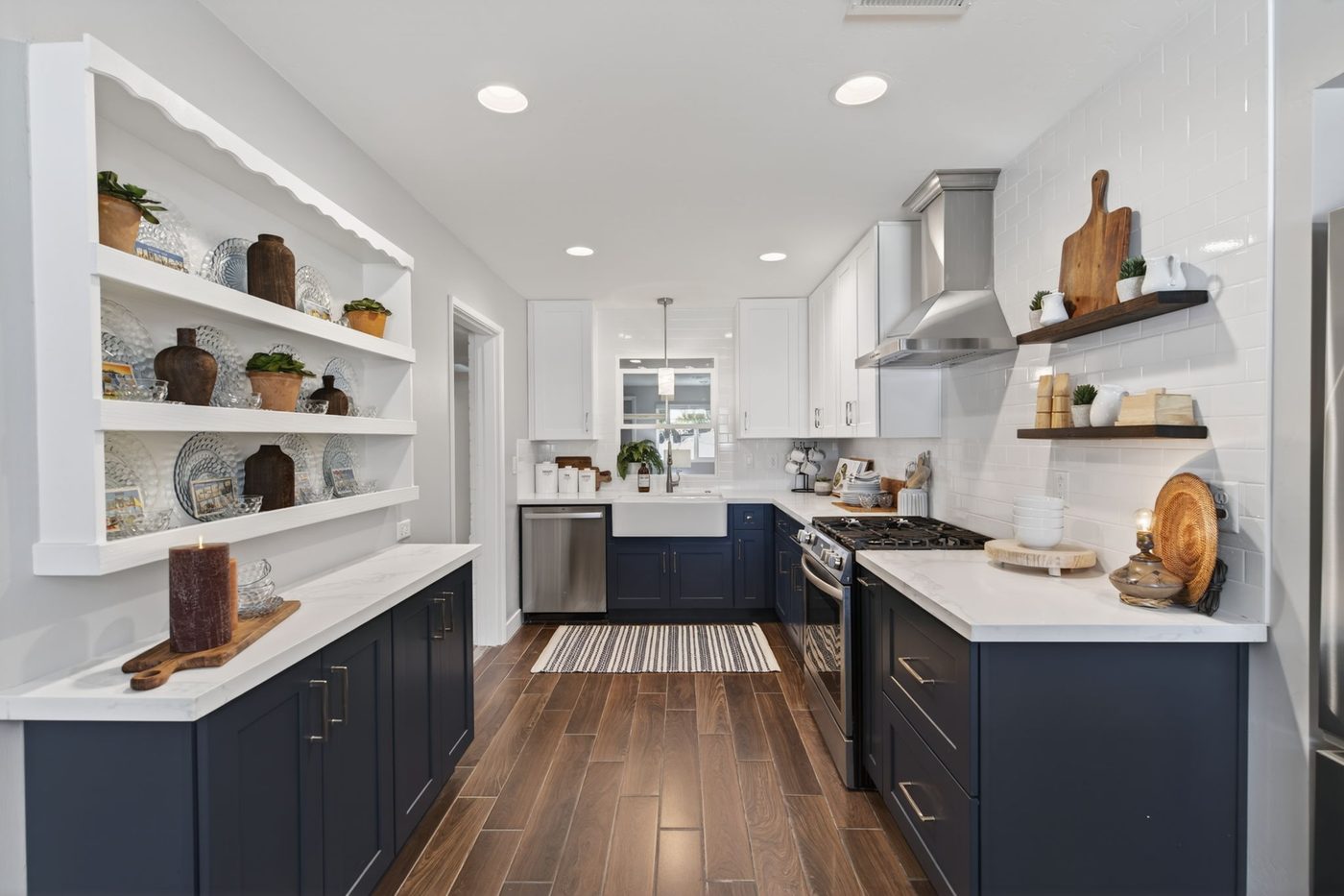 Renovated kitchen with navy cabinetry, quartz counters and a farmhouse sink at 3839 E Vernon Ave, Phoenix